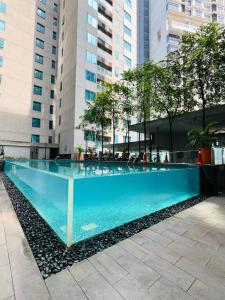 a swimming pool in the middle of a building at Luxury Summer Suites KLCC By LEXA Stay in Kuala Lumpur