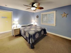 a bedroom with a bed and a ceiling fan at Put-in-Bay Waterfront Condo #113 in Put-in-Bay