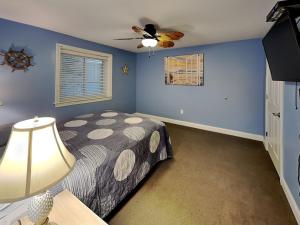 a bedroom with a bed and a ceiling fan at Put-in-Bay Waterfront Condo #113 in Put-in-Bay +18 photos