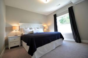 a bedroom with a large bed and a window at Comfortable and Modern Cabin Rental on Lake Red Rock near Pella, Iowa in Pella