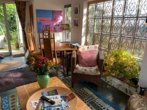 a living room with a table and a chair at Crow Cottage in Briston