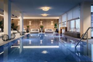 a hotel lobby with a pool in the middle at Mount Med Resort in Oberau