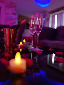 two wine glasses sitting on top of a table at Mansa Apartments in Bradford