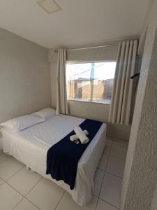 a small bedroom with a bed with a towel on it at Hotel Ruy Barbosa in Eunápolis