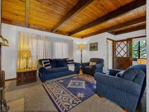 a living room with two blue couches and a rug at Snowflake Chalet in Government Camp +41 photos