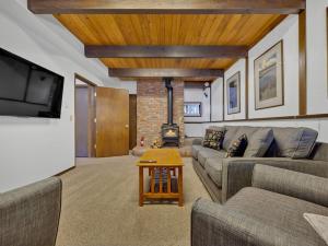 a living room with two couches and a fireplace at Snowflake Chalet in Government Camp