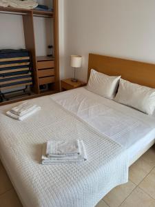 a bedroom with a bed with a towel on it at T1 Apartment Cabanas in Cabanas de Tavira