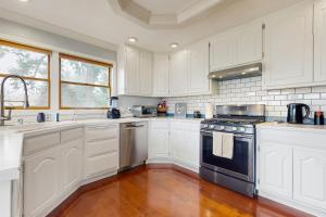 a kitchen with white cabinets and a stove top oven at Saltwater Shoreline in Shoreline +13 photos