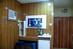 a room with a tv on a wooden wall at Ontario Suites in Lagos