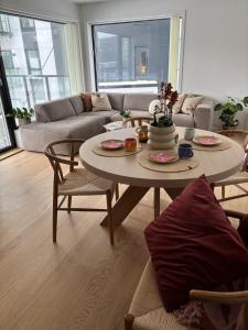 a living room with a table and a couch at Luxury Seaside Apartment Tromsø in Tromsø