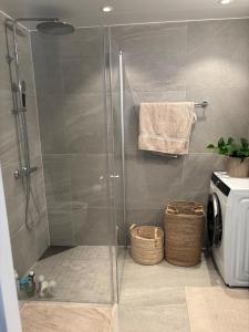 a shower with a glass door in a bathroom at Luxury Seaside Apartment Tromsø in Tromsø +24 photos