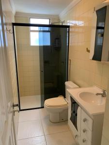 a bathroom with a shower and a toilet and a sink at Spacious & Artistic Apartment in Belém in Belém +36 photos