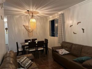 a living room with a couch and a dining table at Spacious & Artistic Apartment in Belém in Belém