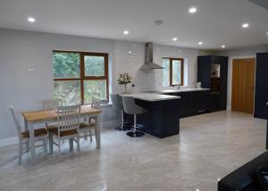 a kitchen and dining room with a table and chairs at Forrest view in Dunfanaghy