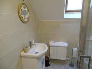 a bathroom with a sink and a toilet and a window at Forrest view in Dunfanaghy +7 photos