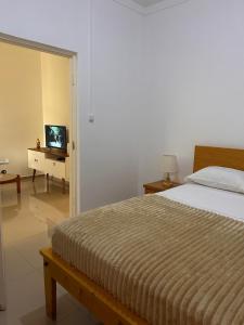 a bedroom with a large bed and a television at Sun & Sea Tarrafal in Tarrafal +34 photos