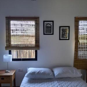 En eller flere senge i et værelse på La Casita Vacapy + 2 billeder