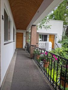 a porch of a house with a black fence at Quinta María Hotel Boutique & Spa in Querétaro +3 photos