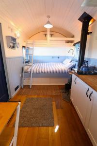 a small room with a bunk bed in a kitchen at Badger's Den Shepherd's Hut in Mollington