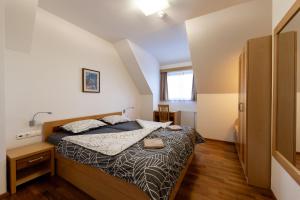 a bedroom with a bed in a small room at Luxury apartments Prežin in Pohorje