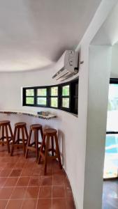 a group of stools in a room with windows at Casa Je'elel Chuburna Puerto in Chuburná