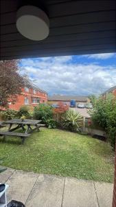 a picnic table and a picnic table in a yard at Affordable Single Room in Saltney