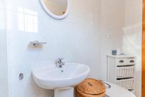 a white bathroom with a sink and a toilet at RentitSpain Casa Estrella del Mar, a 400 metros de la playa in Castell de Ferro +68 photos