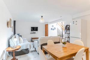 a dining room and living room with a table and chairs at RentitSpain Casa Estrella del Mar, a 400 metros de la playa in Castell de Ferro