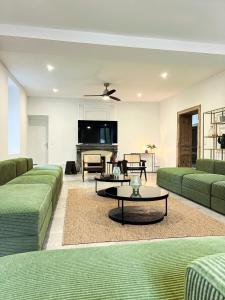 a living room with green couches and a table at DOMAINE De PLAISANCE in Cachen +57 photos