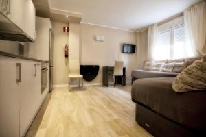 a living room with a couch and a table at Apartamentos Áncora in Barro de Llanes