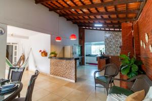 a kitchen and living room with a table and chairs at Recanto dos Passaros - Wifi Garagem Gourmet in Goiânia