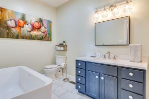 a bathroom with a blue cabinet and a mirror at Pet-Friendly Countryside Retreat in Whiteland! in Whiteland +21 photos