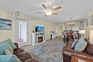 a living room with a couch and a fireplace at Ocean Club Villa C-310 in Biloxi