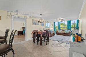a dining room and living room with a table and chairs at Ocean Club Villa C-310 in Biloxi