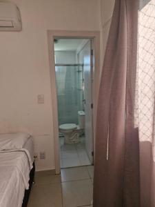 a bedroom with a bathroom with a toilet and a shower at Edificio Versatto Residence in Belém