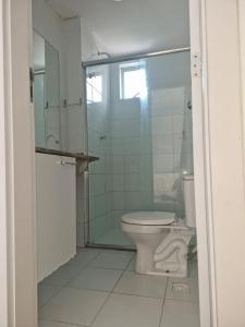 a bathroom with a toilet and a glass shower at Edificio Versatto Residence in Belém +5 photos