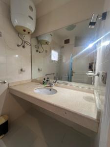 a bathroom with a sink and a large mirror at Charming beachside 5BDR Villa in Einbay in Ain Sokhna +57 photos