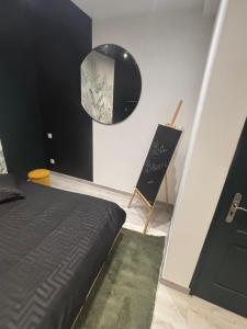 a bedroom with a bed and a chalkboard on the wall at La bohème C.A in Dijon