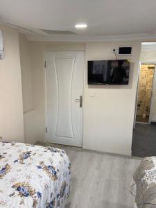 a bedroom with a bed and a door with a television at HOmE SUITE in Istanbul +6 photos