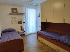 a bedroom with two beds and a cabinet at Panorama Etnea in Santa Maria di Licodia +4 photos