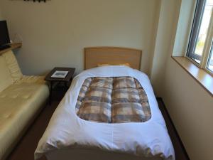 Postel nebo postele na pokoji v ubytování Ryokan Yamaichi