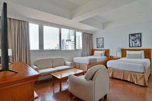 a hotel room with two beds and a television at Hotel Almirante Cartagena Colombia in Cartagena de Indias +136 photos