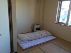 Postel nebo postele na pokoji v ubytování Ryokan Yamaichi