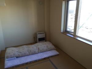 Postel nebo postele na pokoji v ubytování Ryokan Yamaichi