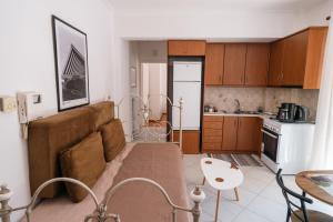 a living room with a couch and a kitchen at TripoliStay in Tripoli