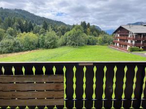 a balcony with a view of a green field at Studio cosy proche du centre in Les Gets