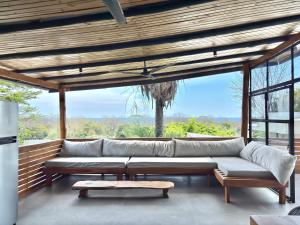 a living room with a couch and a table at NulaKai Boutique Apartments in Santa Teresa Beach