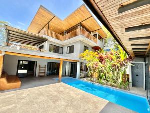 an image of a house with a swimming pool at NulaKai Boutique Apartments in Santa Teresa Beach