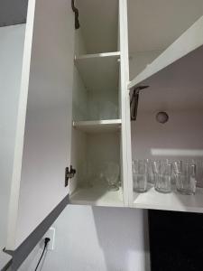 a cupboard with glasses sitting in it at Microcasa 01 in Tangara da Serra