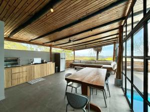 a kitchen and dining room with a table and chairs at NulaKai Boutique Apartments in Santa Teresa Beach